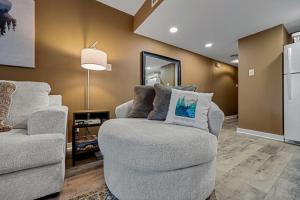 a living room with two chairs and a couch at Bearadise Mountain Getaway by Eden Crest in Sevierville