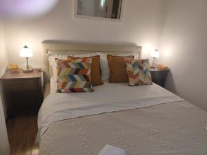 a bedroom with a bed with pillows and two lamps at Apartment Astoria in Krilo