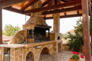 an outdoor kitchen with a stone oven on a patio at Apartment’s Vasileiou Suite 1 in Preveza
