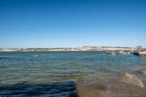 a large body of water with a city in the background at GuestReady - Casas Do Tanoeiro in Porto Brandão