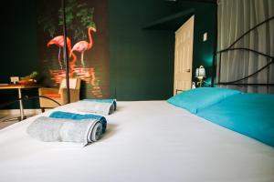 Letto o letti in una camera di Woodstock Palmresort Curaçao
