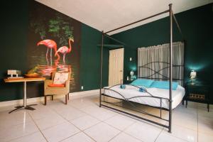Letto o letti in una camera di Woodstock Palmresort Curaçao