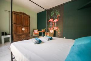 Letto o letti in una camera di Woodstock Palmresort Curaçao