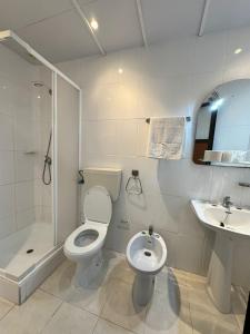 フィゲイラ・ダ・フォズにあるCentral Guest Houseの白いバスルーム(トイレ、シンク付)
