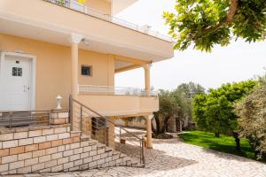 a house with a staircase in front of it at Apartments Vasileiou Suite 4 in Preveza