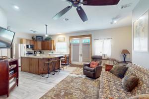a living room with a couch and a kitchen at Mermaid Haven in Mexico Beach