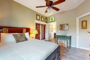 a bedroom with a bed and a ceiling fan at Mermaid Haven in Mexico Beach