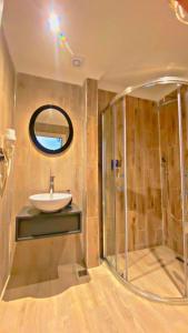 a bathroom with a sink and a shower at Green Nazar Hotel in Trabzon +20 photos