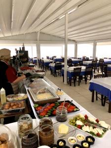 a buffet line with food in a restaurant at Blue Senses Apartments in Sarti