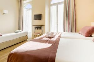 Ліжко або ліжка в номері Hotel Le Havre Bleu