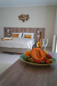 a plate of fruit on a table in a bedroom at Nonna Carmela Holiday House in San Lazzaro Agerola