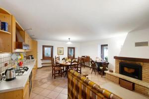 a kitchen and a dining room with a fireplace at Appartamento sotto il Forte di Bard in Bard