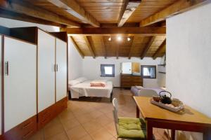 a living room with a table and a bedroom at Appartamento sotto il Forte di Bard in Bard