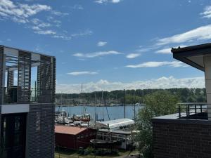 a view of a marina with boats in the water at Penthouse Marina - Sauna und Flussblick in Travemünde