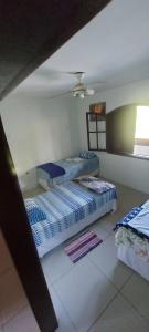 a bedroom with two beds and a ceiling at Pendotiba Hostel in São Gonçalo