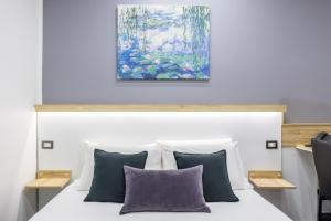 una camera da letto con un letto con sopra un dipinto di Bella Napoli Suites a Napoli