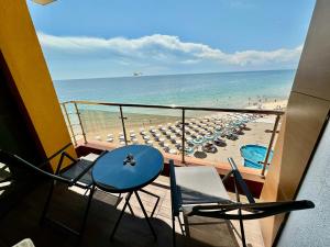 a balcony view of a beach with chairs and umbrellas at Apartment complex Mirage of Nessebar in Nesebar
