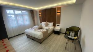 a bedroom with a bed and a table and a chair at Green Nazar Hotel in Trabzon