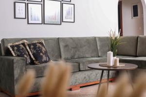 a living room with a gray couch and a table at Luxury and Tranquility - Halicouna's Perfect Gem in Halikounas