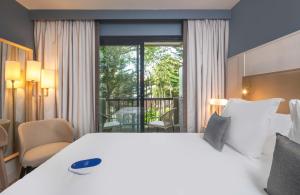 Postel nebo postele na pokoji v ubytování Hôtel Arcanse by Inwood Hotels