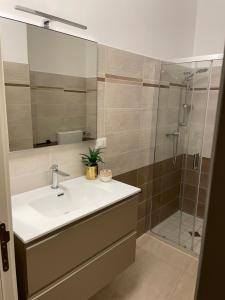 a bathroom with a sink and a shower at Dimora Valentina in Tricase +24 photos