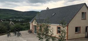 a group of bikes parked outside of a house at Glencolumbkille House - Self Catering Rooms in Glencolumbkille