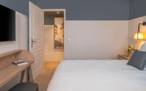 Postel nebo postele na pokoji v ubytování Hôtel Arcanse by Inwood Hotels