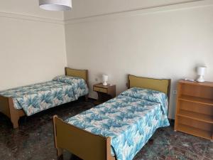 a room with two beds and a dresser at Blue Sea House in Chioggia