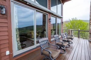 a row of chairs on a porch with windows at Pipers Paradise in Beech Mountain