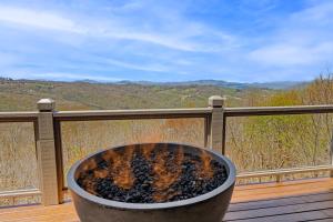 a fire pit on a deck with a view at Pipers Paradise in Beech Mountain