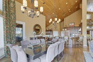 a dining room with a glass table and chairs at Pipers Paradise in Beech Mountain +38 photos