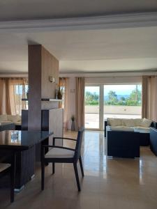 a living room with a table and a couch at Aktaion apartments in Artemísion