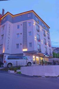 a building with a van parked in front of it at Green Nazar Hotel in Trabzon