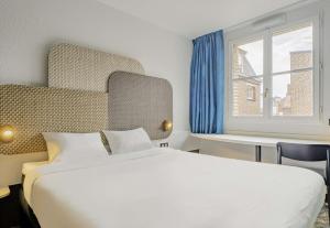 Postel nebo postele na pokoji v ubytování B&B HOTEL Arras Centre Les Places