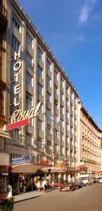 a large building with a hotel sign on a street at Hotel Royal in Vienna