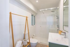 a bathroom with a shower and a toilet and a sink at TrendyHomes Zapillo Beach - Primera línea de playa in Almería +20 photos