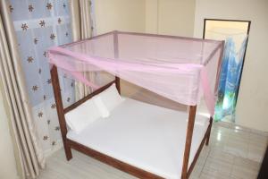 a pink bunk bed in a room at Booster Villa Mtwapa in Mtwapa