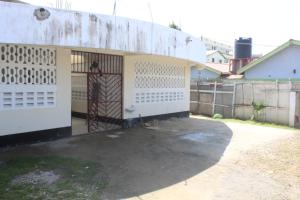 a building with a gate and a fence at Booster Villa Mtwapa in Mtwapa