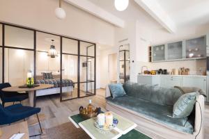 a living room with a couch and a table at SAINTE ANNE by Time Off Collection in Saint-Tropez