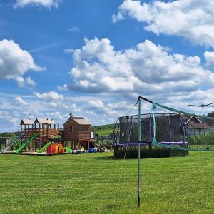 a playground with a net in a grass field at Morskie Sarbinowo in Sarbinowo