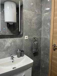 a bathroom with a sink and a mirror at Apartman DEA in Bihać +37 photos