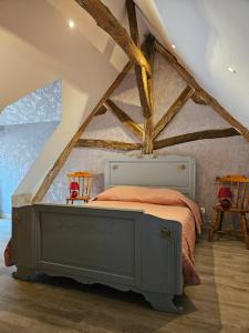 a bedroom with a bed in a attic at Moulin de Galerne, Le gite du Meunier in Seigy