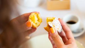 a person holding two donuts in their hands at Palazzo Zacà in Gallipoli