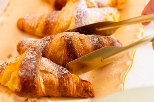 a person cutting up a pastry with a fork at Palazzo Zacà in Gallipoli