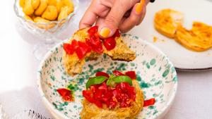 a person holding a piece of food on a plate at Palazzo Zacà in Gallipoli
