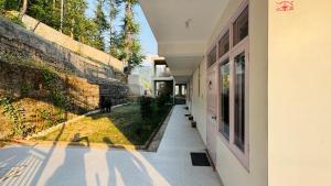 a hallway of a house with a view of a yard at Craignano Homestay & Family suite rooms in Shimla +11 photos