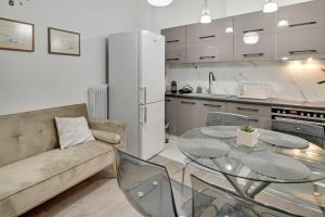 a living room with a couch and a glass table at Academia stay ήσυχα & στο Κέντρο in Ioannina