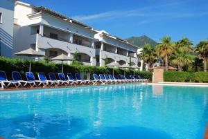 a swimming pool with lounge chairs and a hotel at Sognu di Rena privilege Top appartament view sea in San-Nicolao