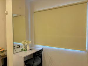 a large window in a room with a mirror at Calm and Cozy- Tffstays in Lucknow