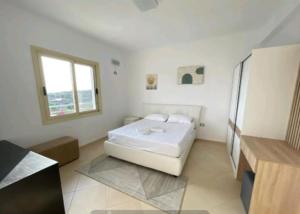 a white room with a bed and a window at Villa Agim,Hena in Vlorë